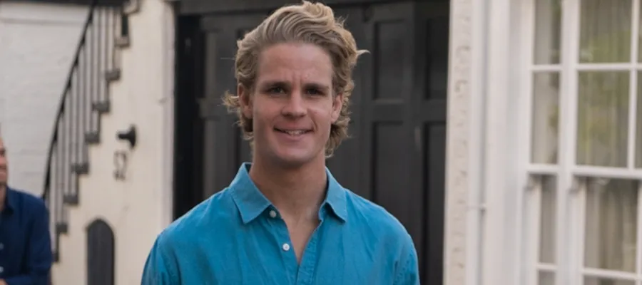 Man in blue shirt looking at camera