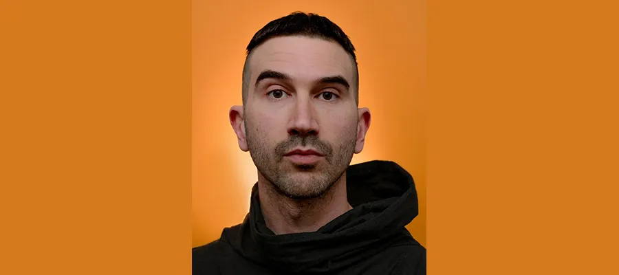 Man looking to camera on orange background